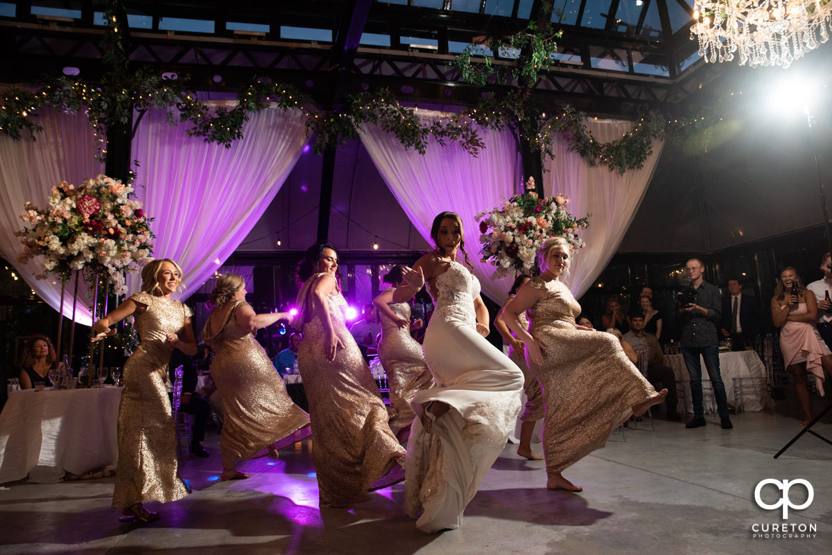 Bridesmaids doing a choreographed dance at the reception.