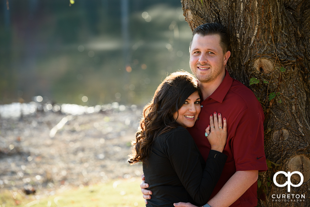 Engaged couple by the lake at Furman.
