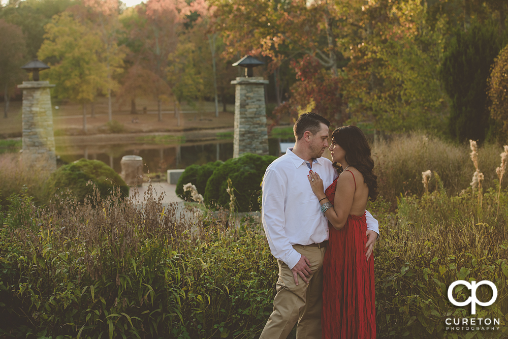 Engaged couple by the lake at Furman University.