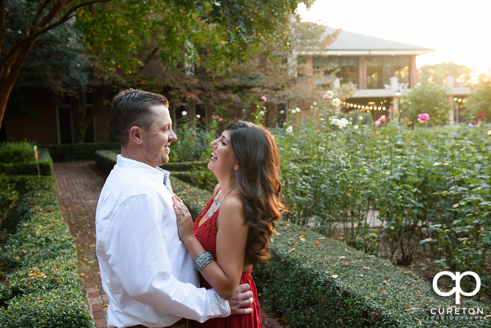 Couple laughing in the garden at their engagement session at Furman.
