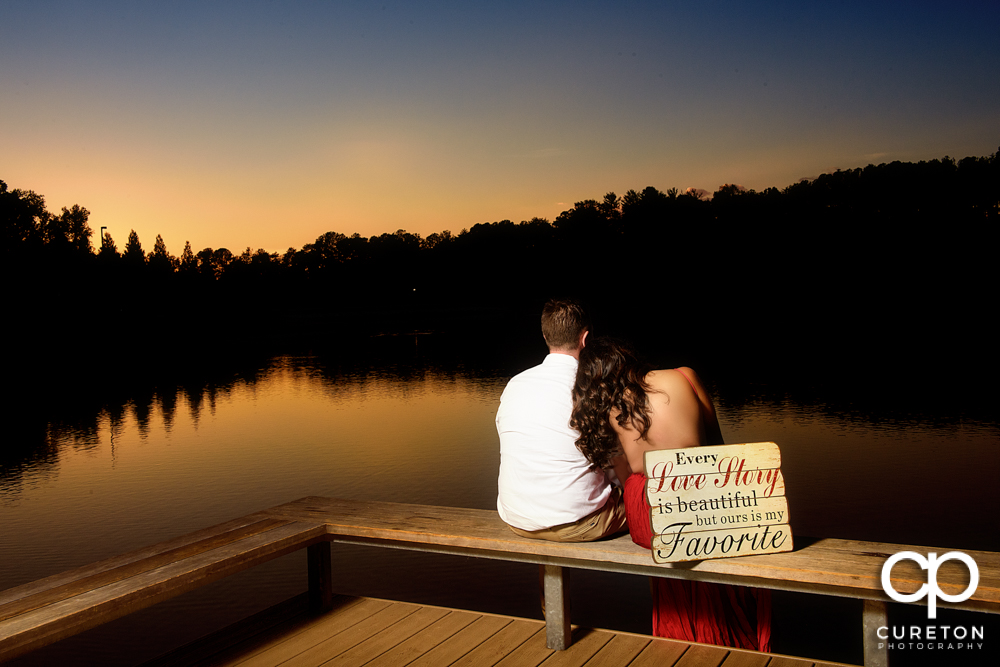 Bride and groom viewing sunset by the lake.