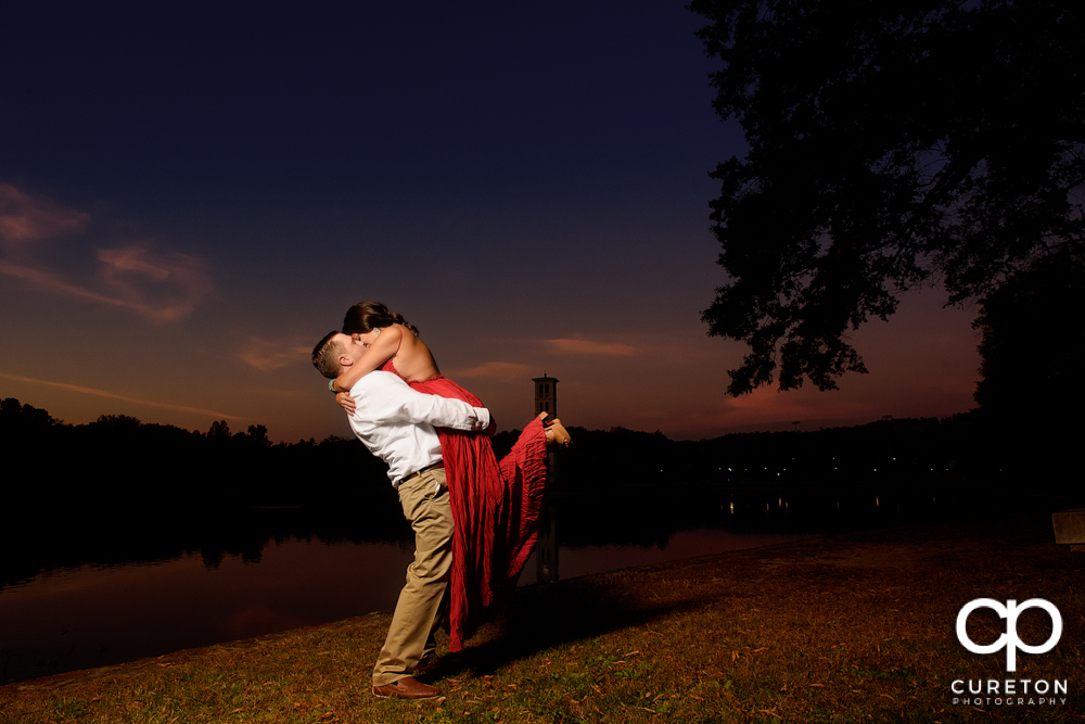 Bride and groom dancing at sunset during their engagement session at Furman university.