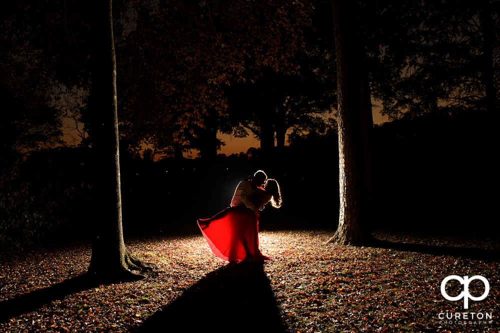Bride and groom dancing in the forest.