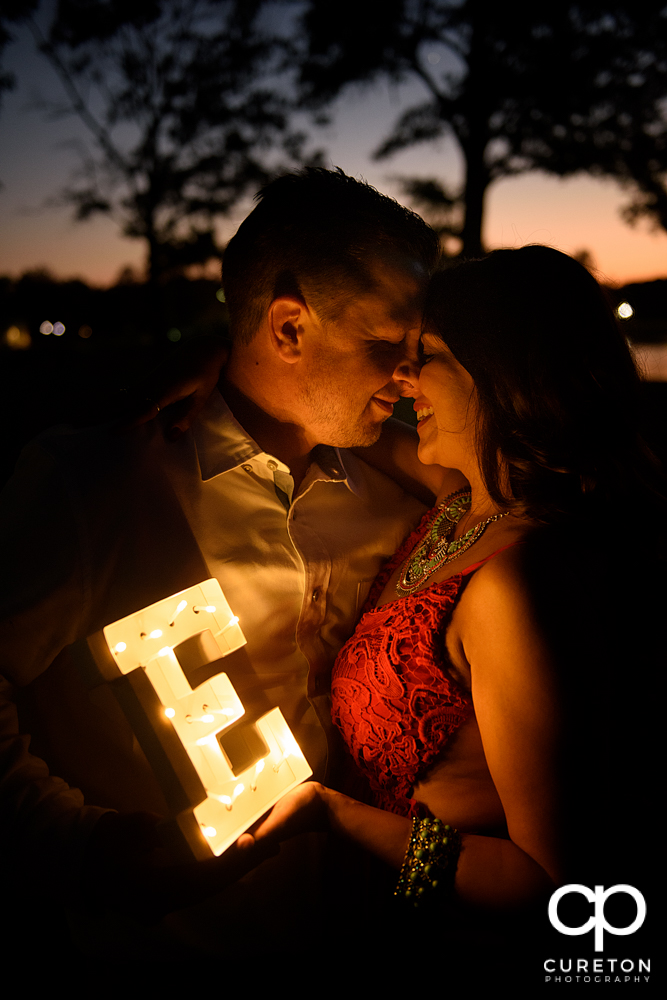 Bride and groom holding a letter.