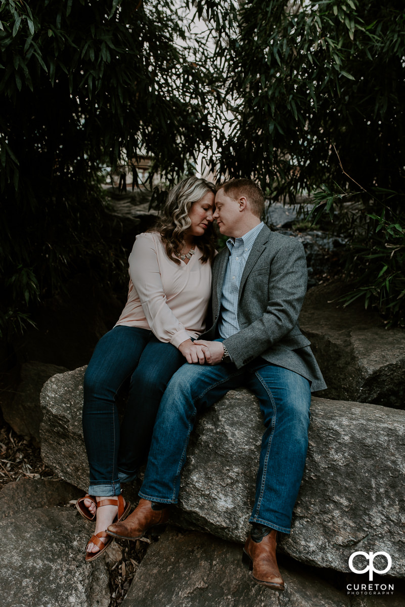 Engaged couple nose to nose during their Rock Quarry Garden Engagement Session in downtown Greenville,SC.