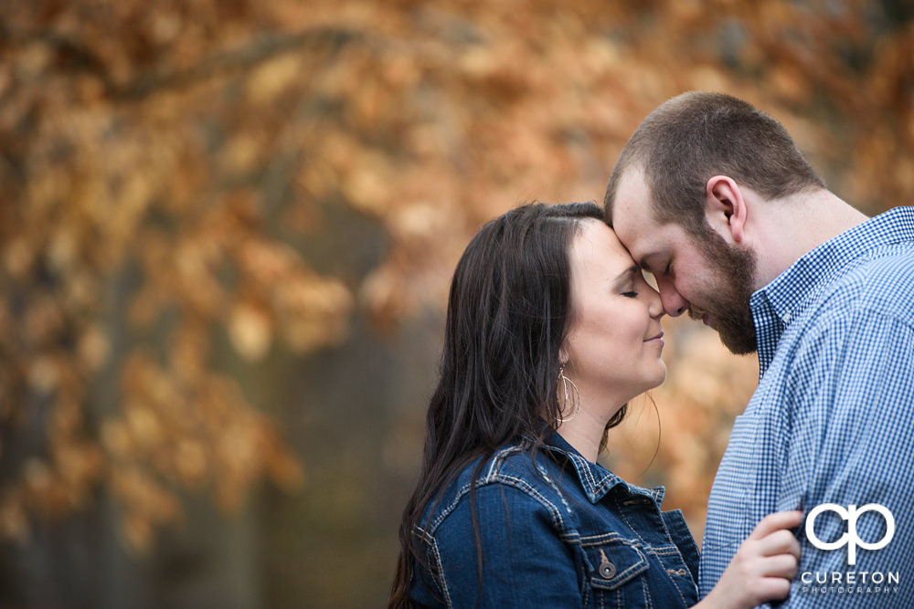Couple nose to nose during a recent engagement session in Falls Park on the Reedy River.