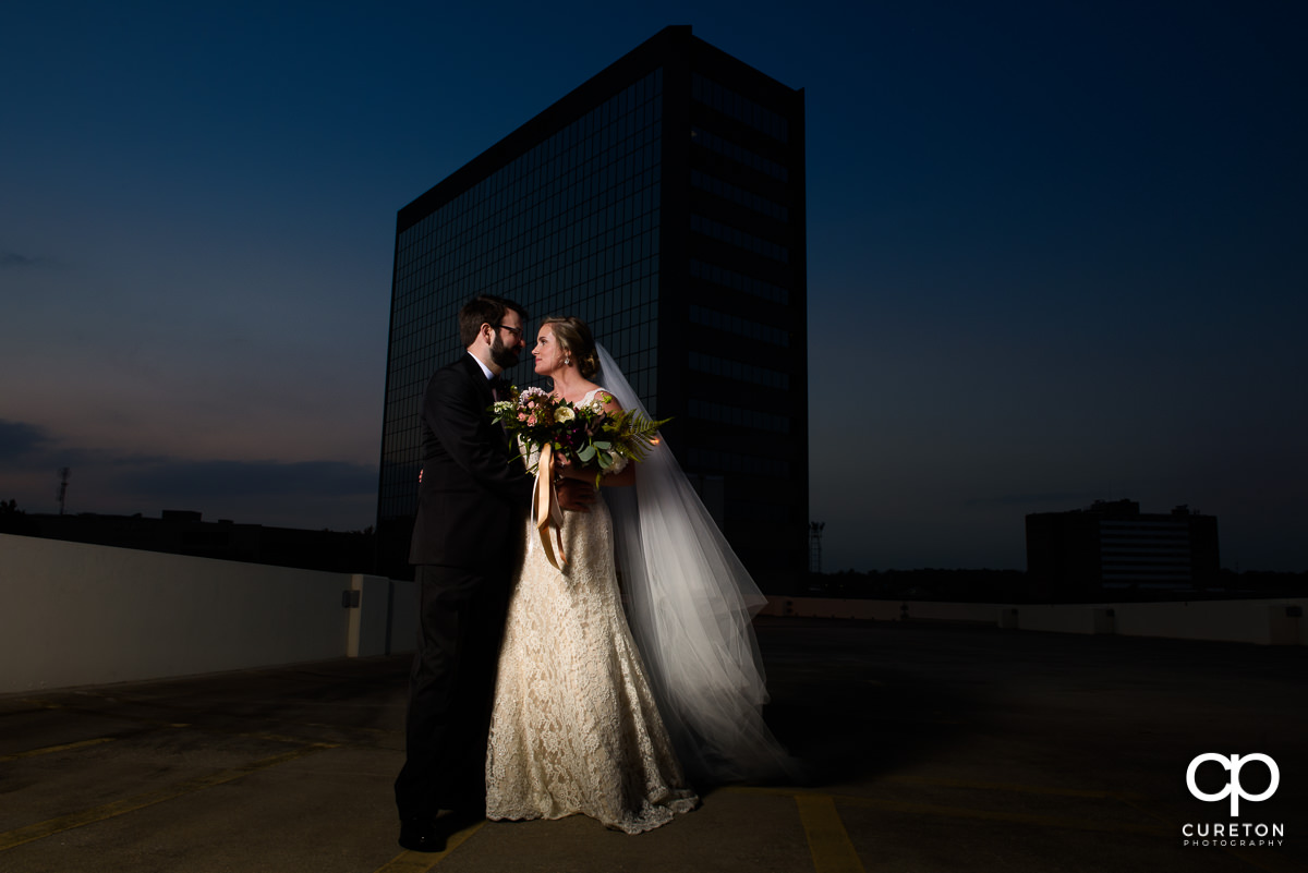 Bride and groom on a rooftop at sunset after their Commerce Club wedding.