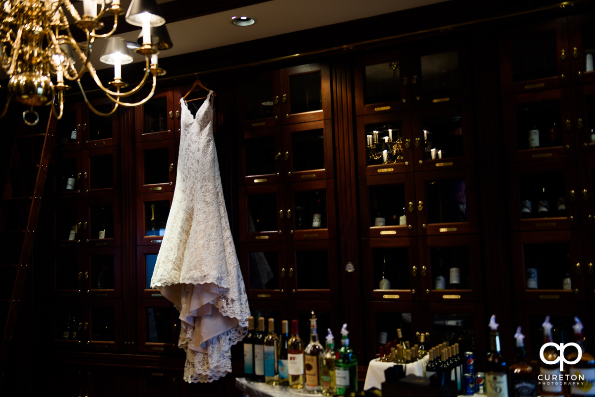 Bride's dress hanging in the wine room at the Commerce Club.