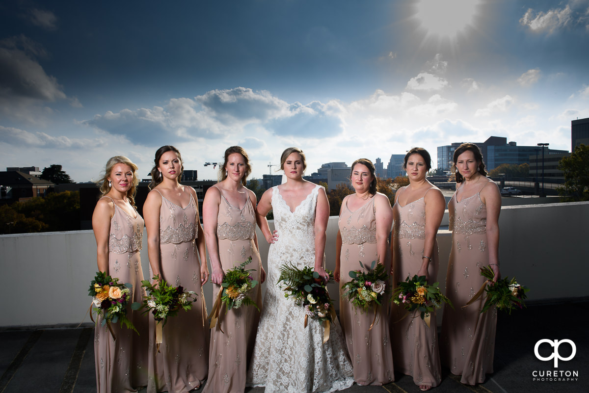 Bride and bridesmaids on a rooftop in downtown Greenville before the wedding.