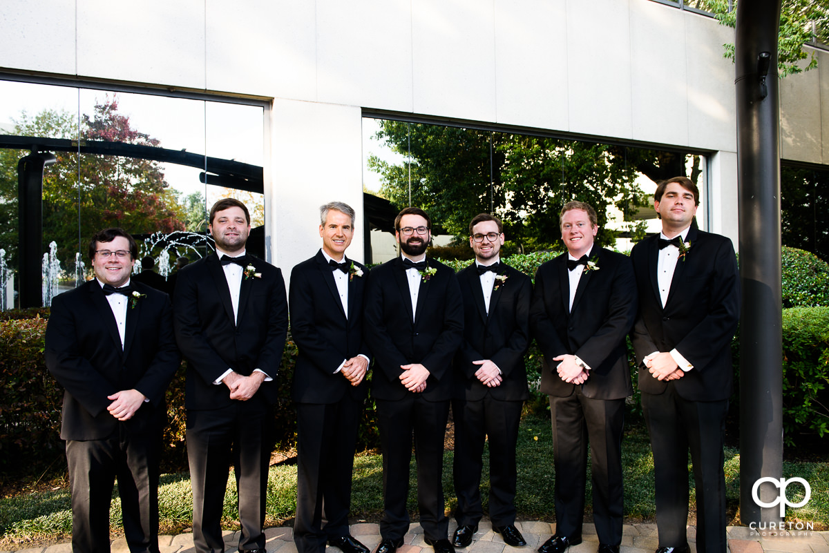 Groom and groomsmen in front of the Commerce Club.