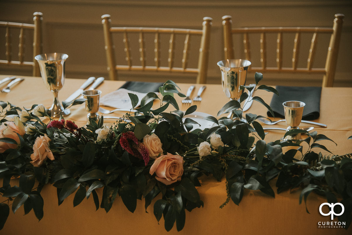 Florals on the wedding party table.