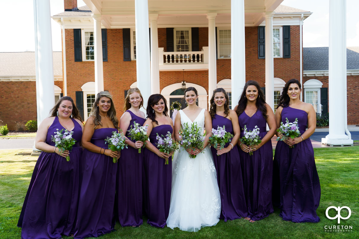 Bride and her bridesmaids in front of the country club.