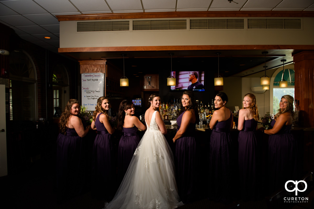 Bride and her bridesmaids sitting at the bar before the wedding.