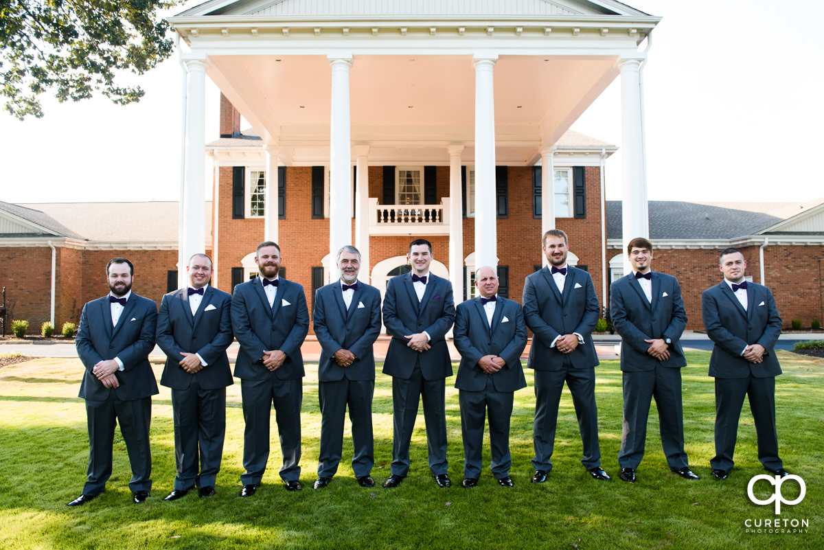 Groom and groomsmen in front of the country club.
