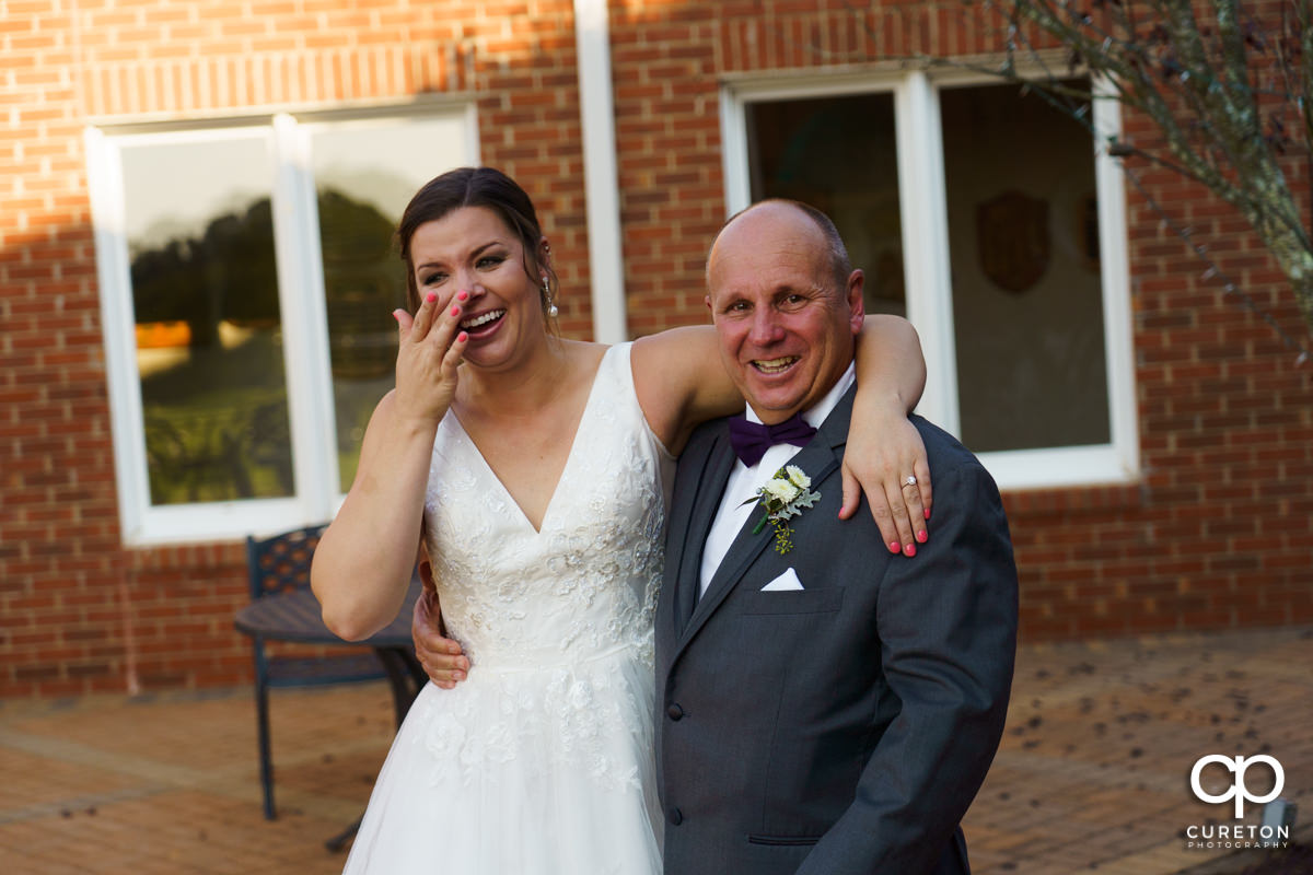 Bride and her dad wiping away tears after a first look.