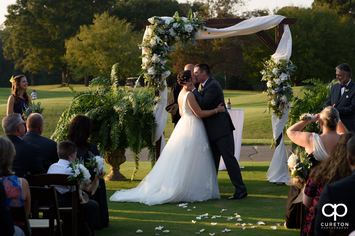 First kiss at the golf course wedding.