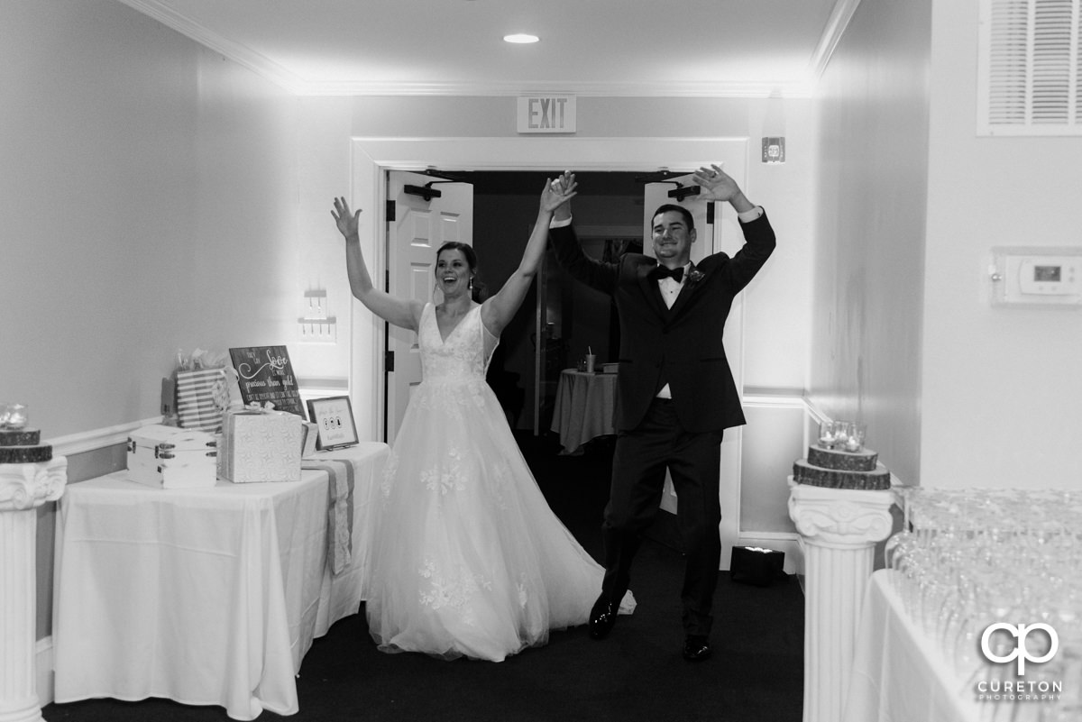 Newlyweds making an entrance into the reception.