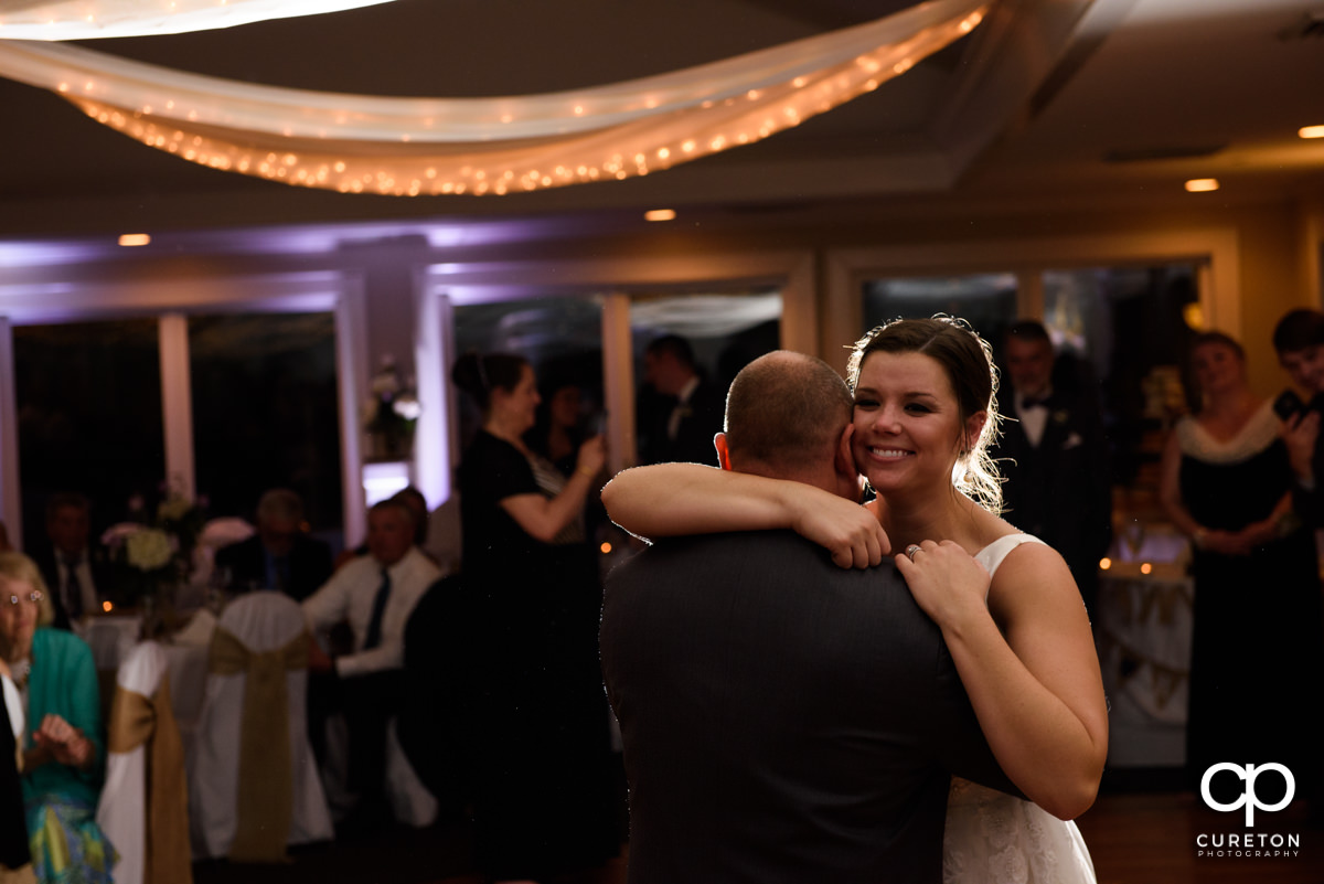 Bride hugging her dad at the wedding reception.