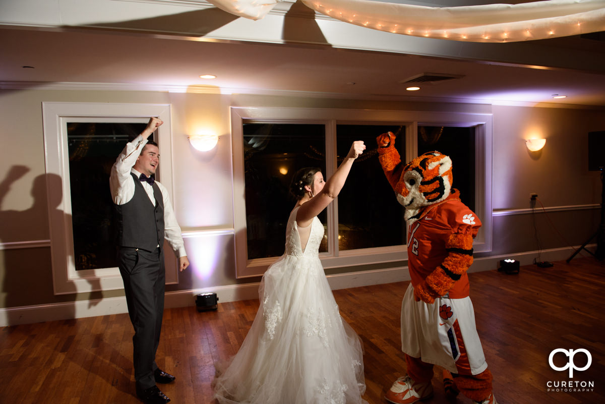Bride and groom dancing with the Clemson Tiger.