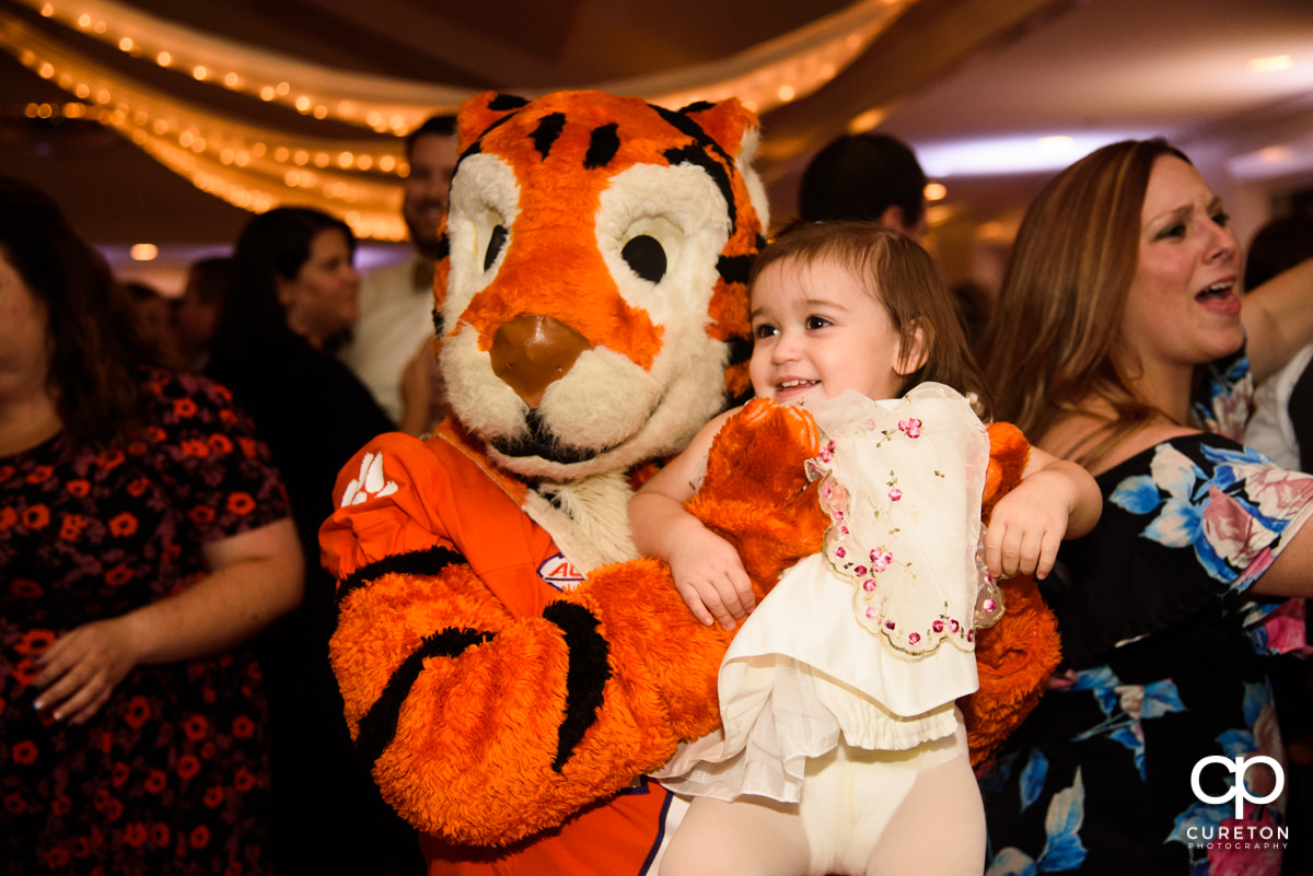 Clemson Tiger holding a baby at the reception.