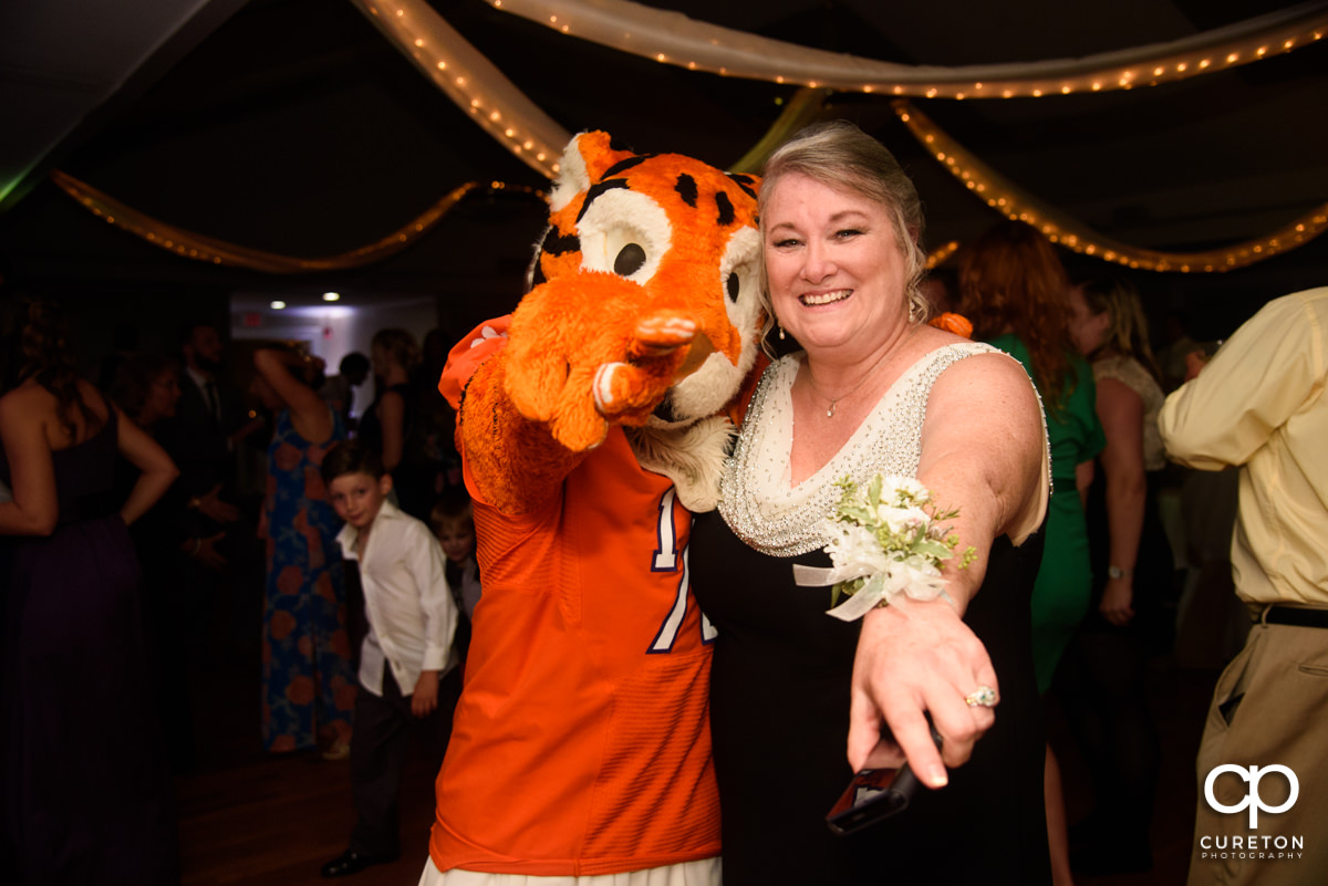 Groom's mother posing with the Clemson Tiger Cub at the wedding reception.