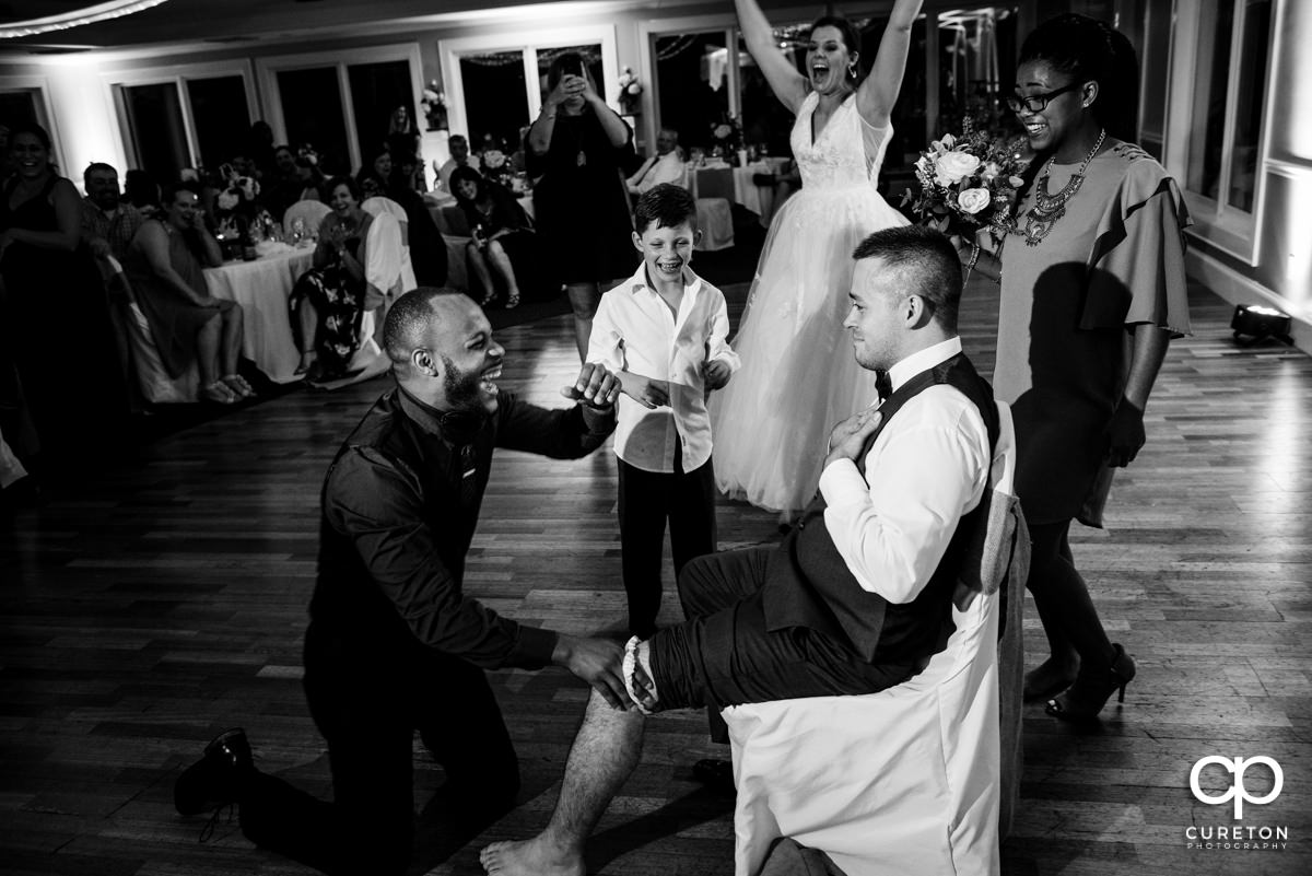The person who caught the garter tricked into putting it onto a groomsmen,