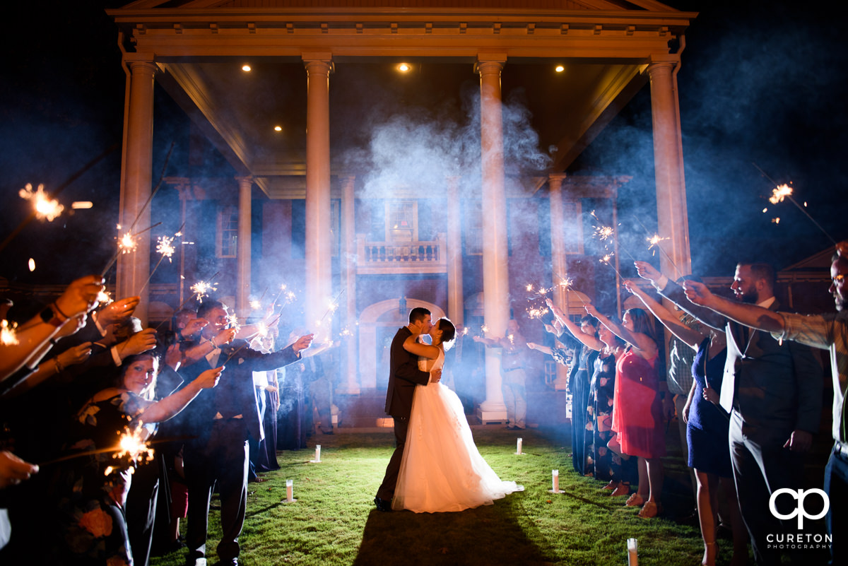 Bride and groom making an epic grand sparkler exit at their Holly Tree Country Club wedding reception.