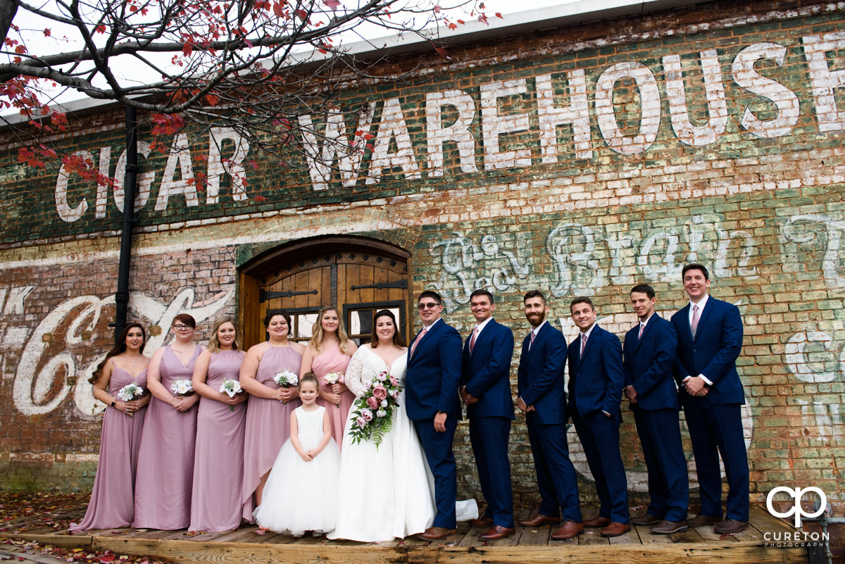 Wedding party standing on the back deck of the Old Cigar Warehouse after the ceremony.