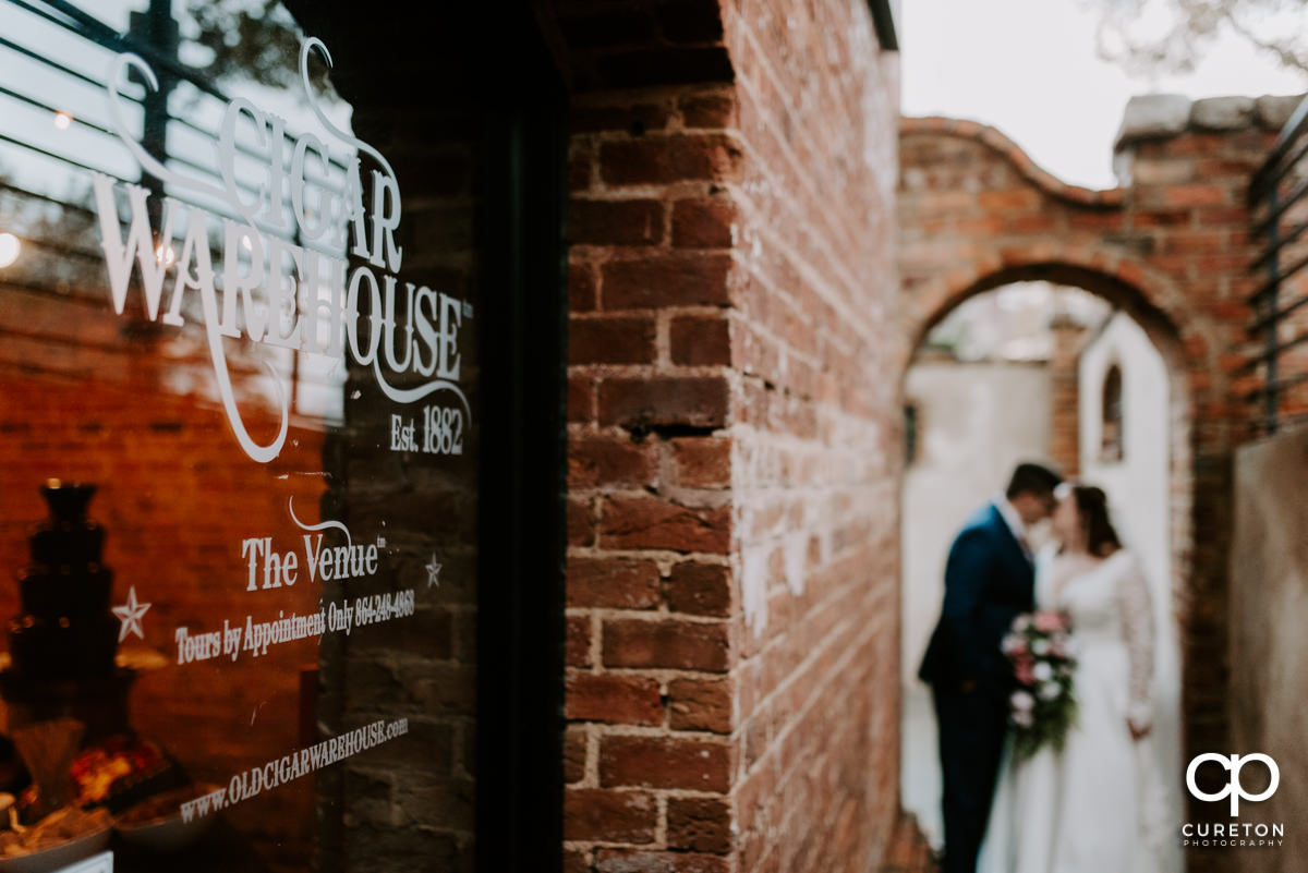 Bride and groom in the background of the Old Cigar Warehouse sign.