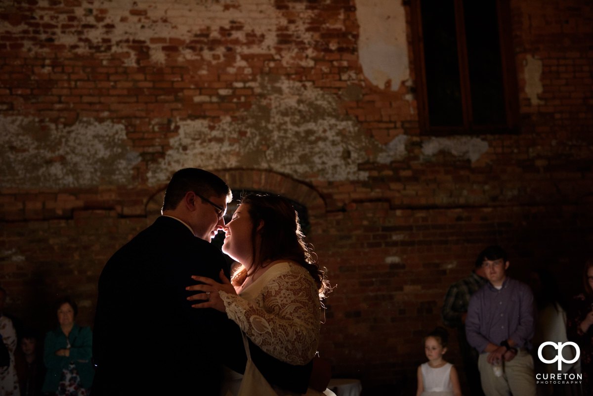 Bride and groom sharing a first dance at the Old Cigar Warehouse reception.