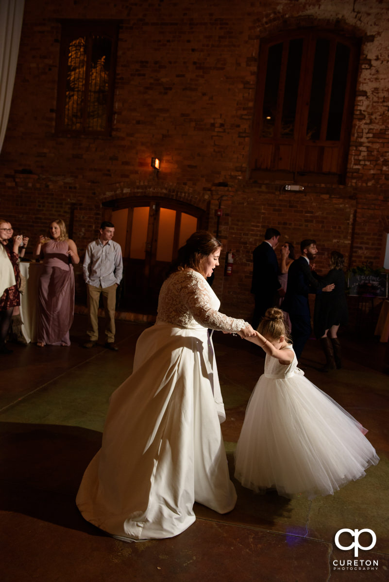 Bride dancing with the flower girl.