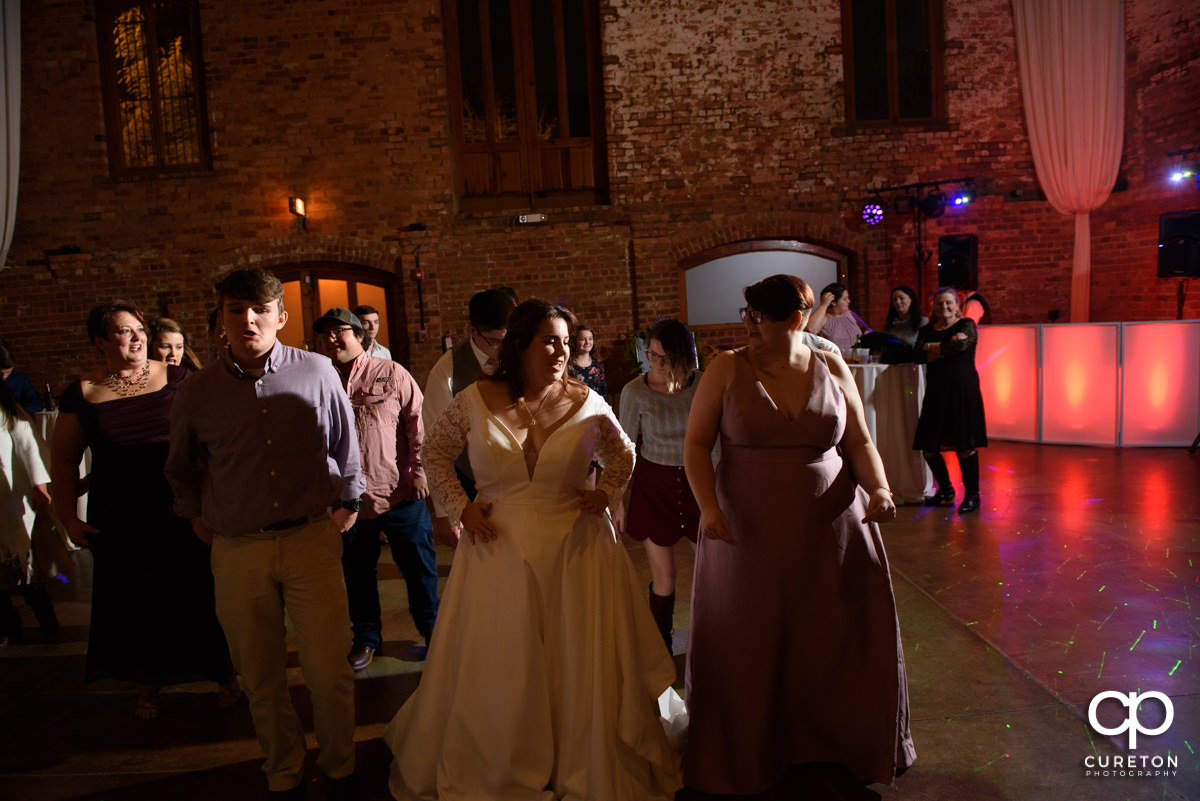 Wedding guests dancing at the wedding reception.