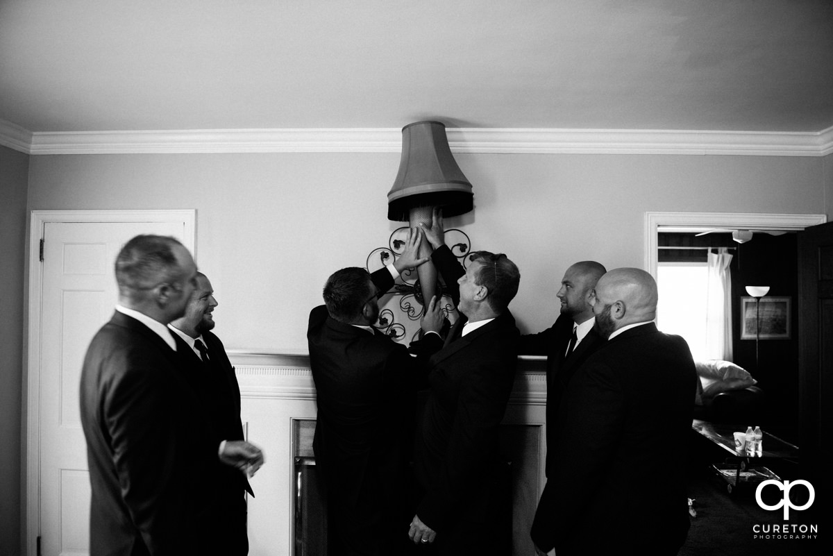Groom and groomsmen looking at a leg lamp from A Christmas Story.