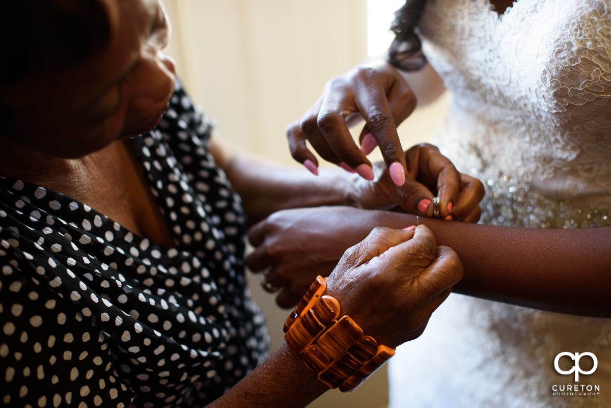 Bride putting on jewelry.