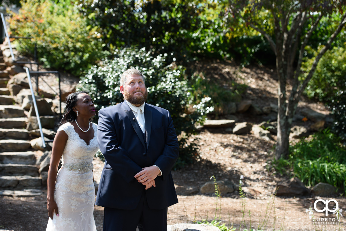 Bride sneaking up on her groom for the first look.