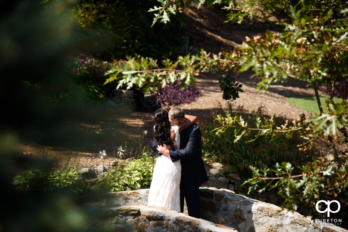 Groom hugging his bride at the first look.