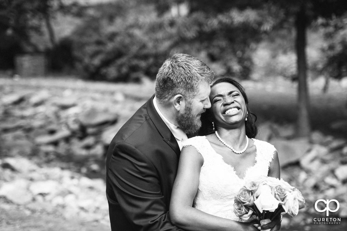 Groom making his bride laugh.