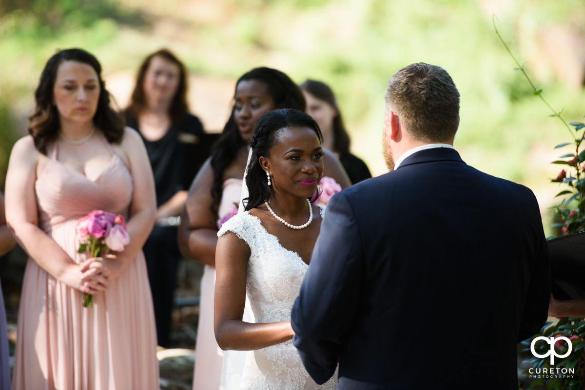 Bride smiling during the wedding ceremony.