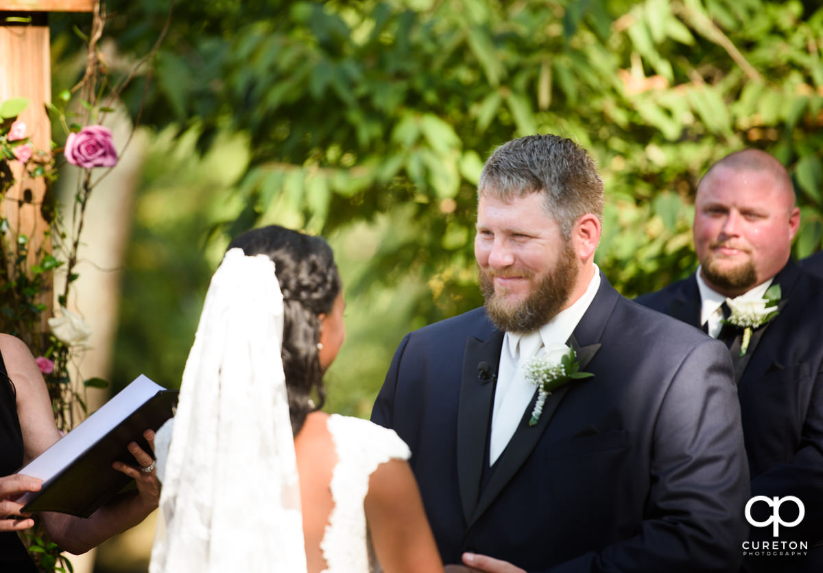 Groom smiling at his bride.