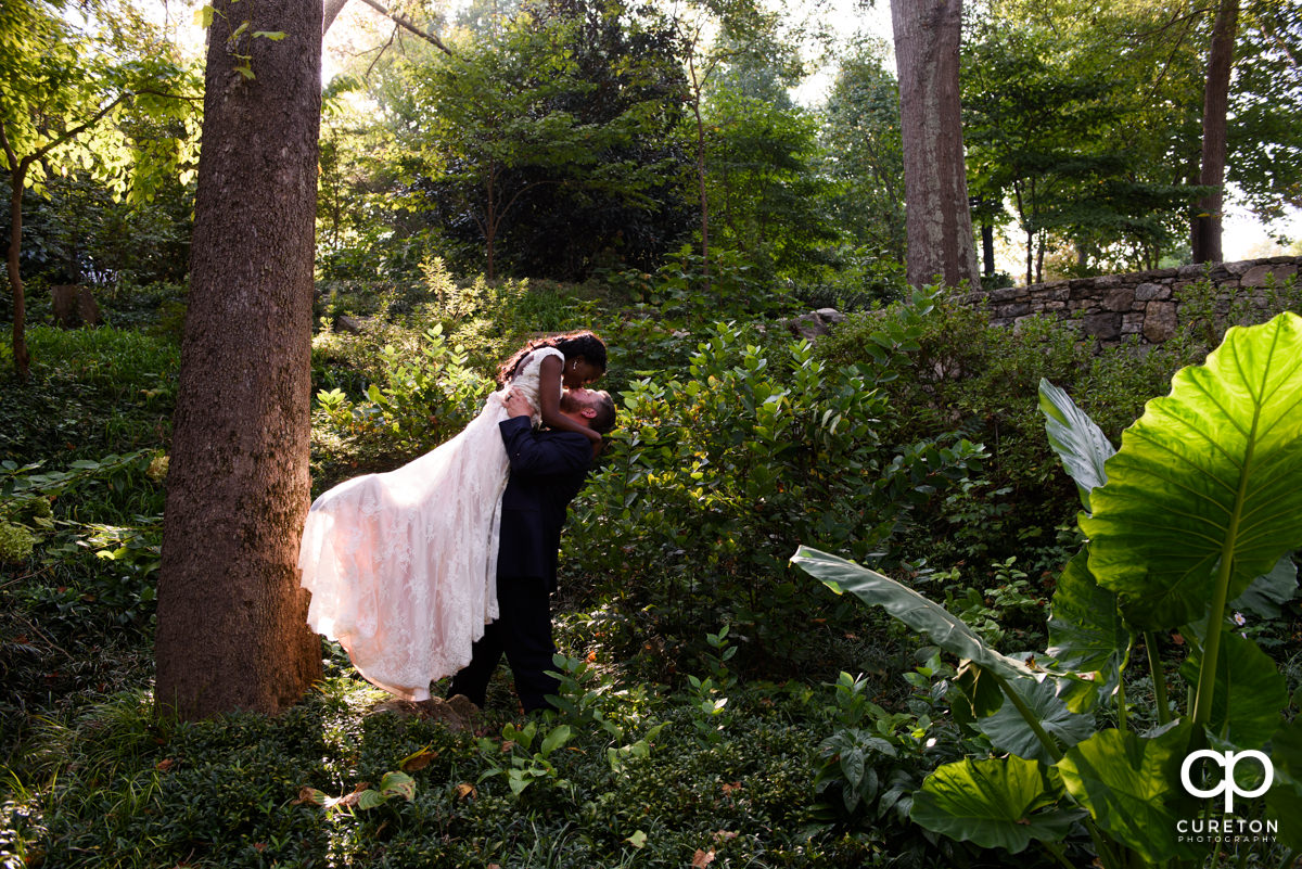 Groom lifting his bride.