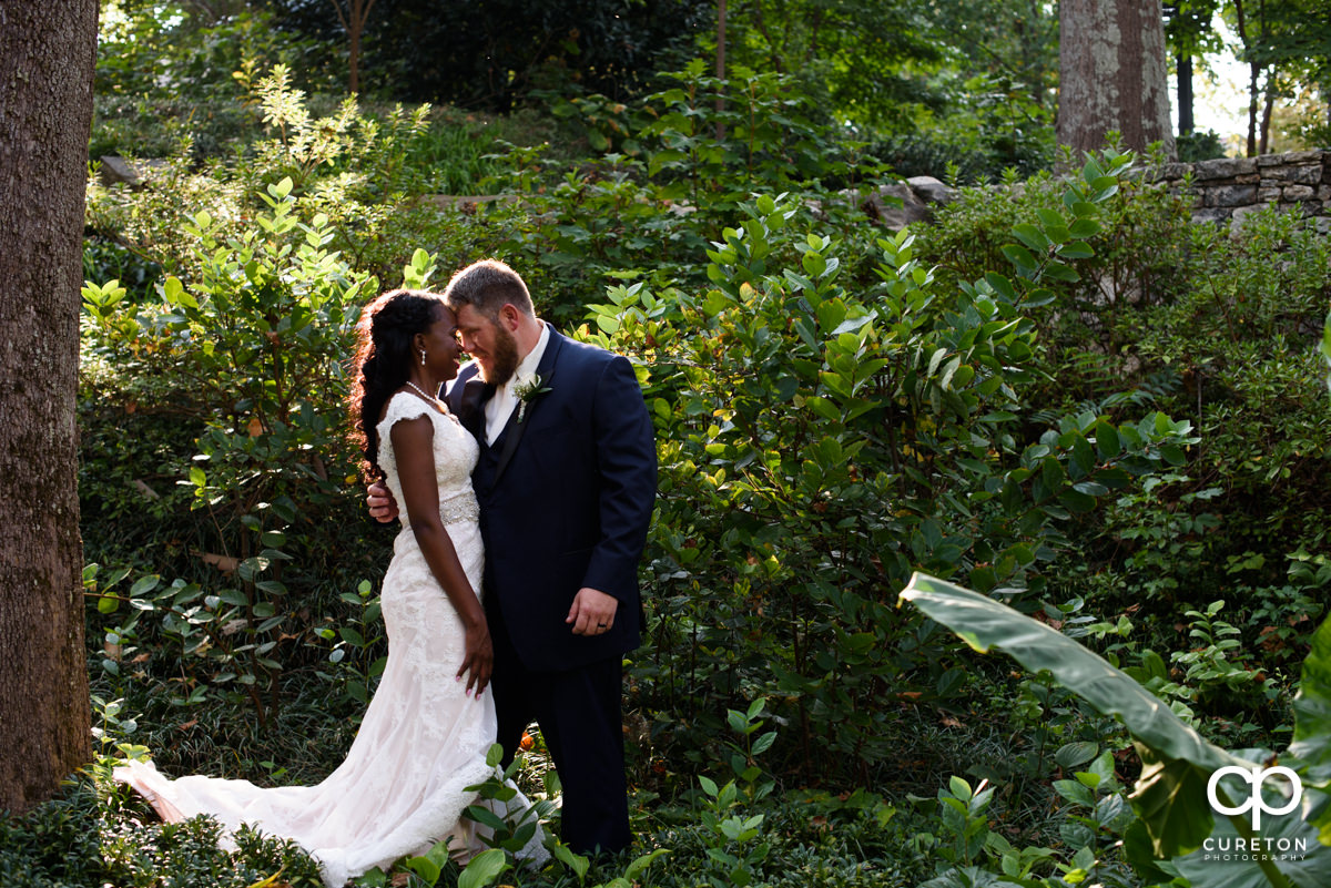 Married couple hugging after their wedding at Falls Park.