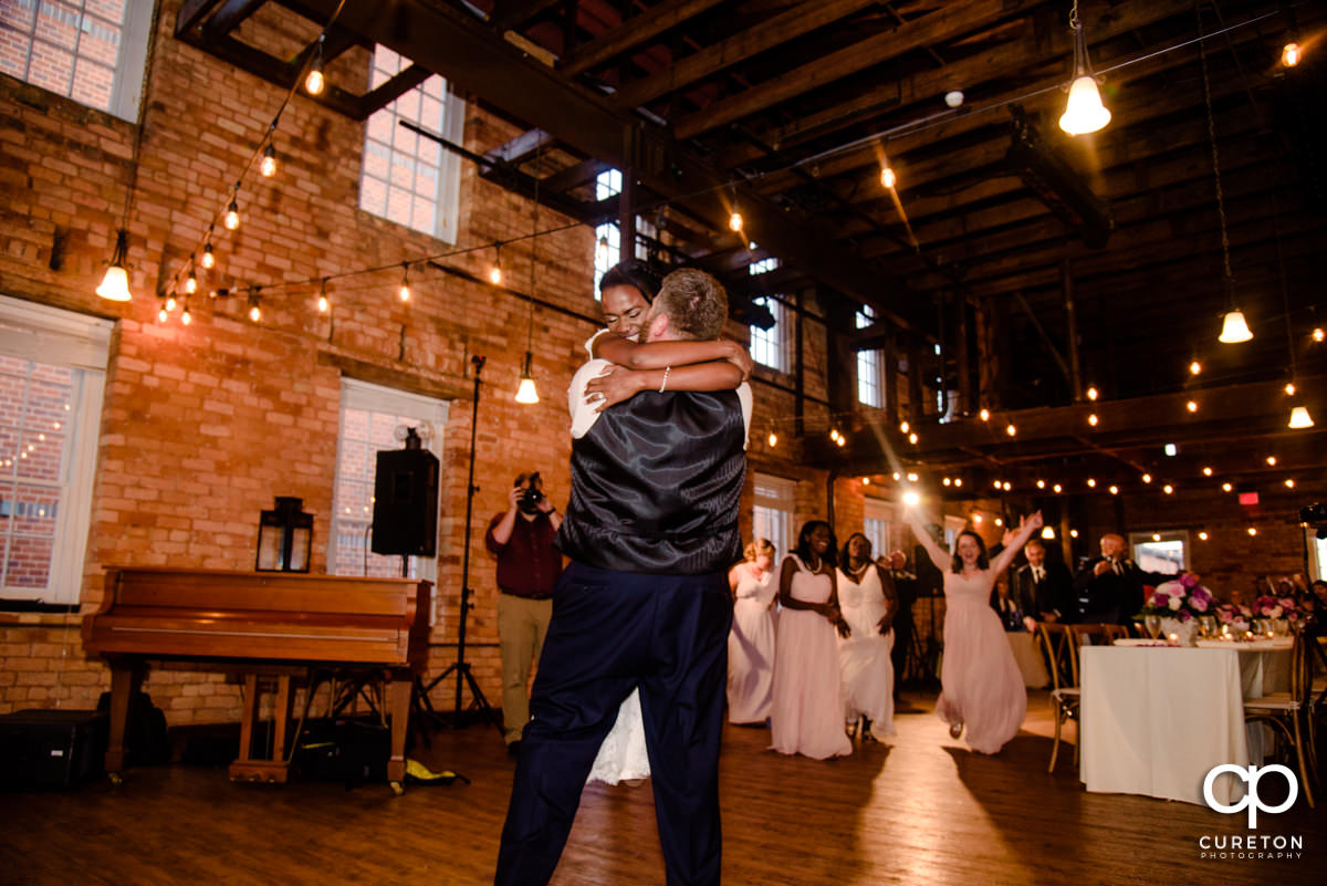 Bride and groom reenact the Dirty Dancing lift during their first dance.