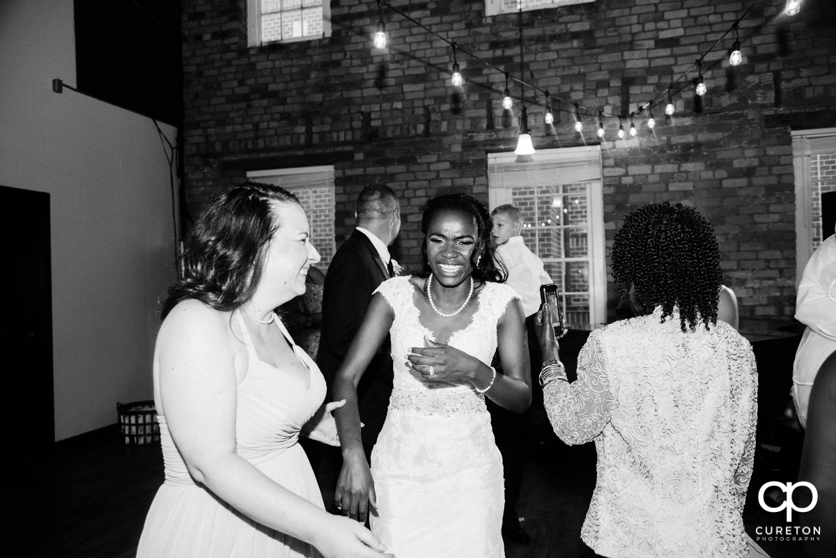 Bride and her friends laughing at the reception.