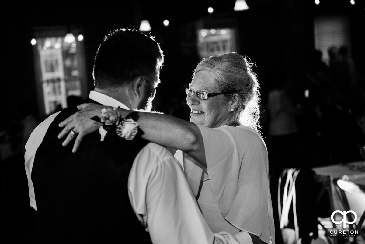 Groom dancing with his mother.