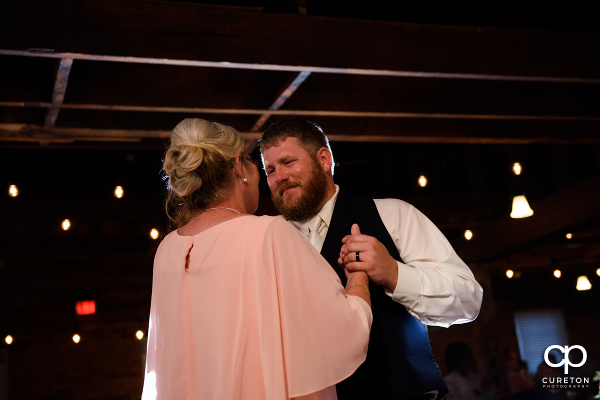 Groom dancing with his mom at the reception.