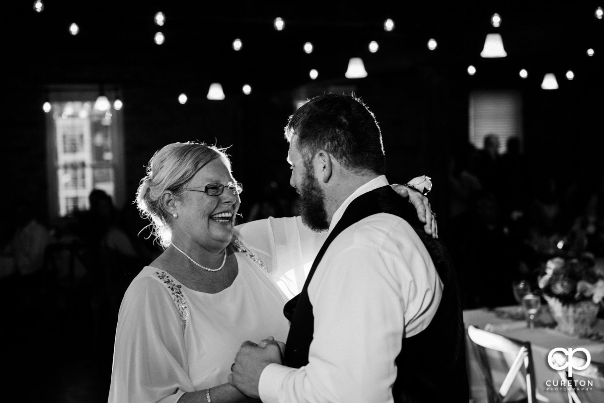 Groom and mom dancing.