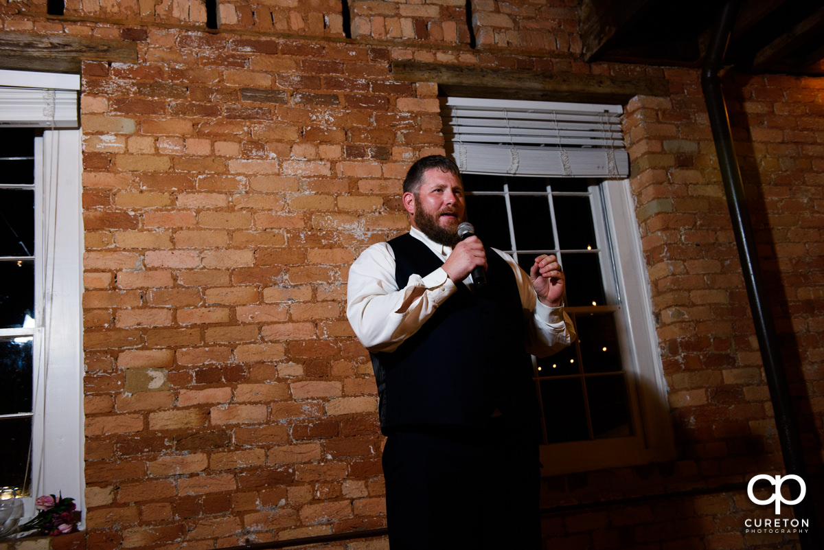 Groom giving a speech at his wedding.