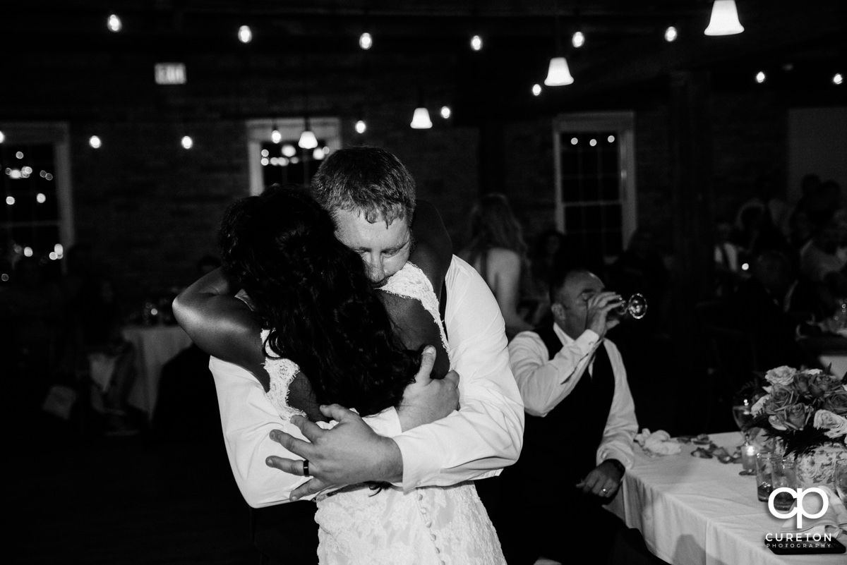 Bride and groom hugging after his speech.