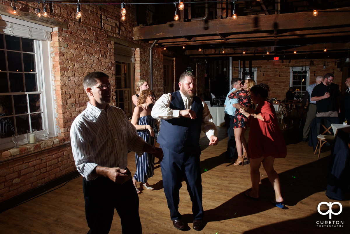 Groom dancing at the reception.