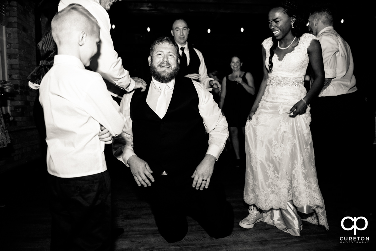 Groom on the floor dancing.